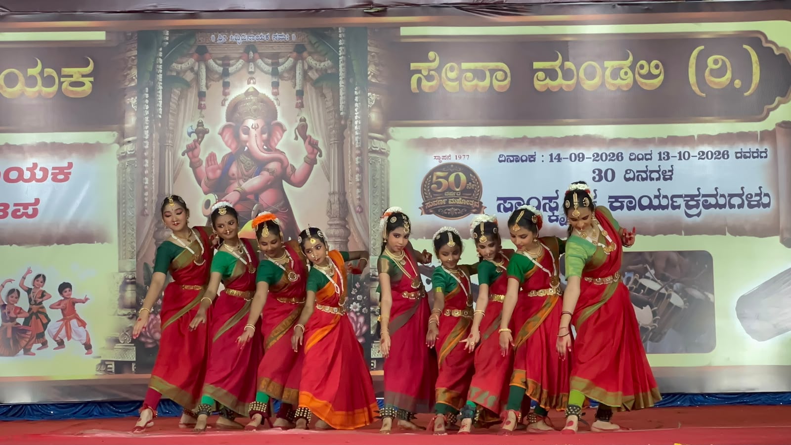 A group of Bharatanatyam dancers performing a coordinated pose