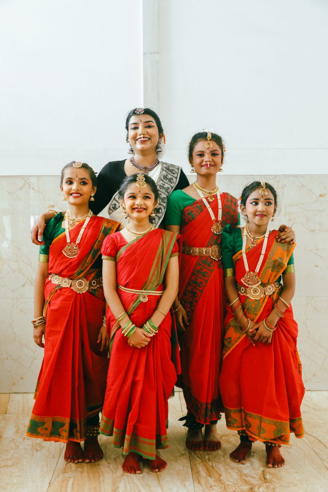 Teacher with four students dressed for a Bharatanatyam performance